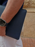 navy blue leather MacBook sleeve, debossed Noirex mark, lifestyle